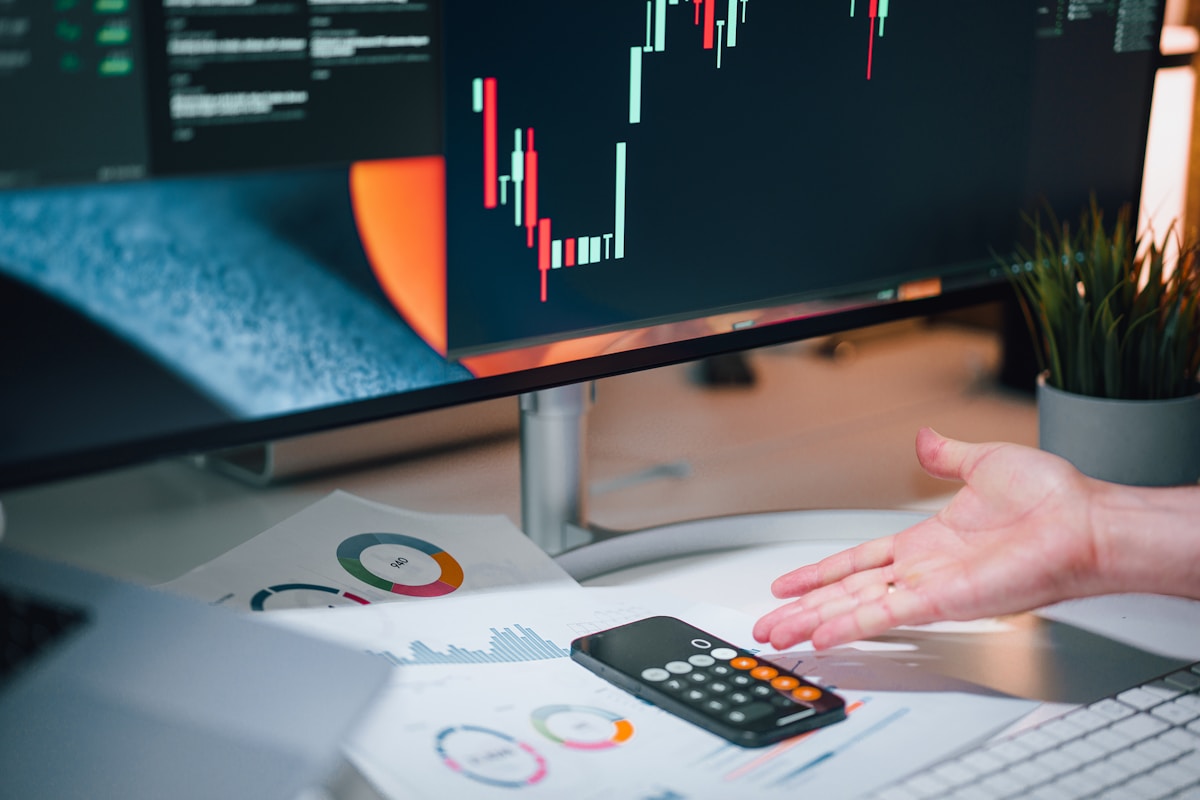 Analyst using a calculator and reviewing figures